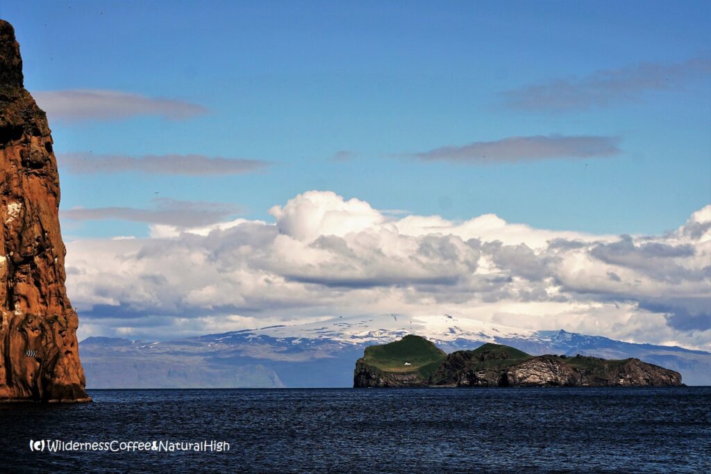 Elliðaey and Eyjafjallajökull, Vestmannaeyjar, Iceland.