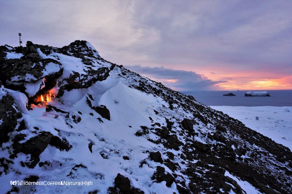 Candle and sunset on Helgafell, Vestmannaeyjar, Iceland.