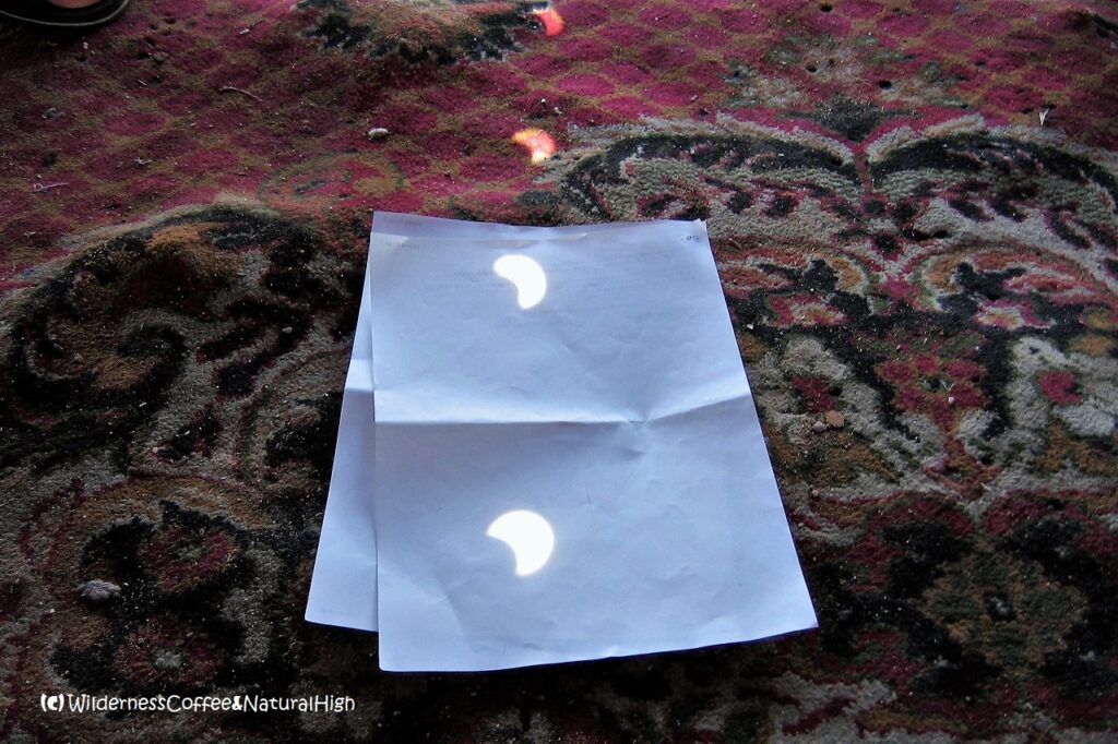 Eclipse pinhole reflections.