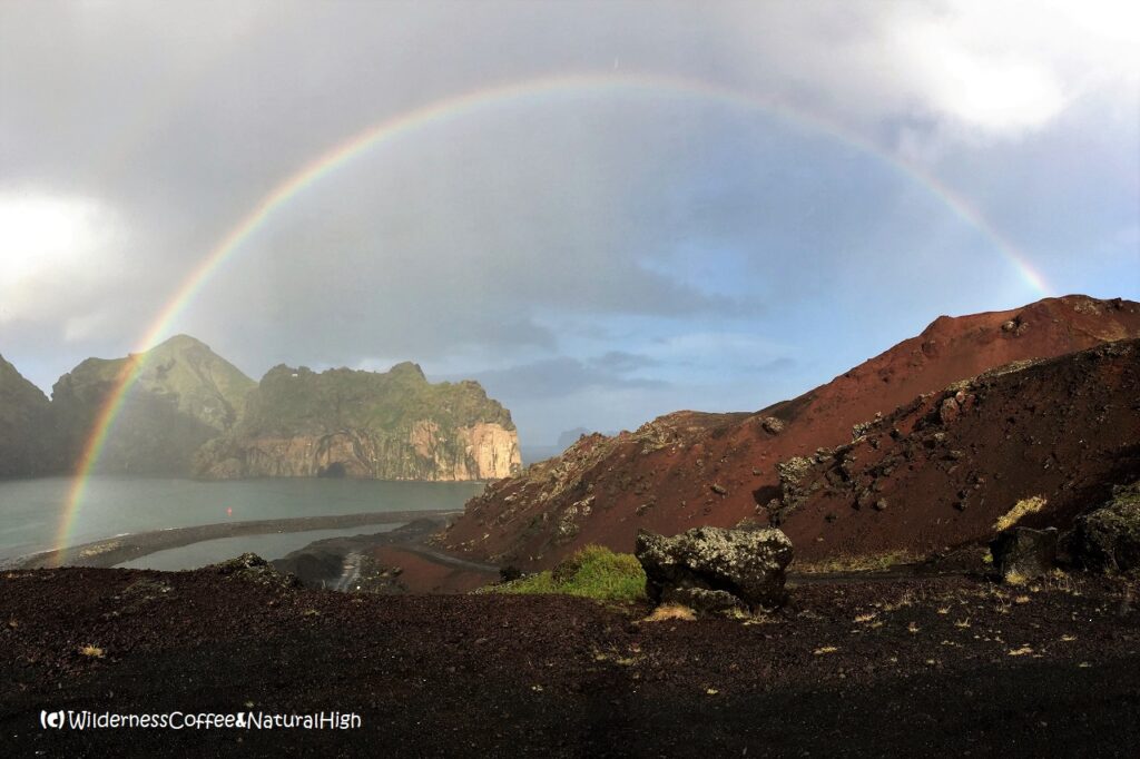 Rainbow over Heimaey harbour and Eldfell lava fields Rainbow over Heimaey harbour and Eldfell lava fields, Vestmannaeyjar, Iceland.