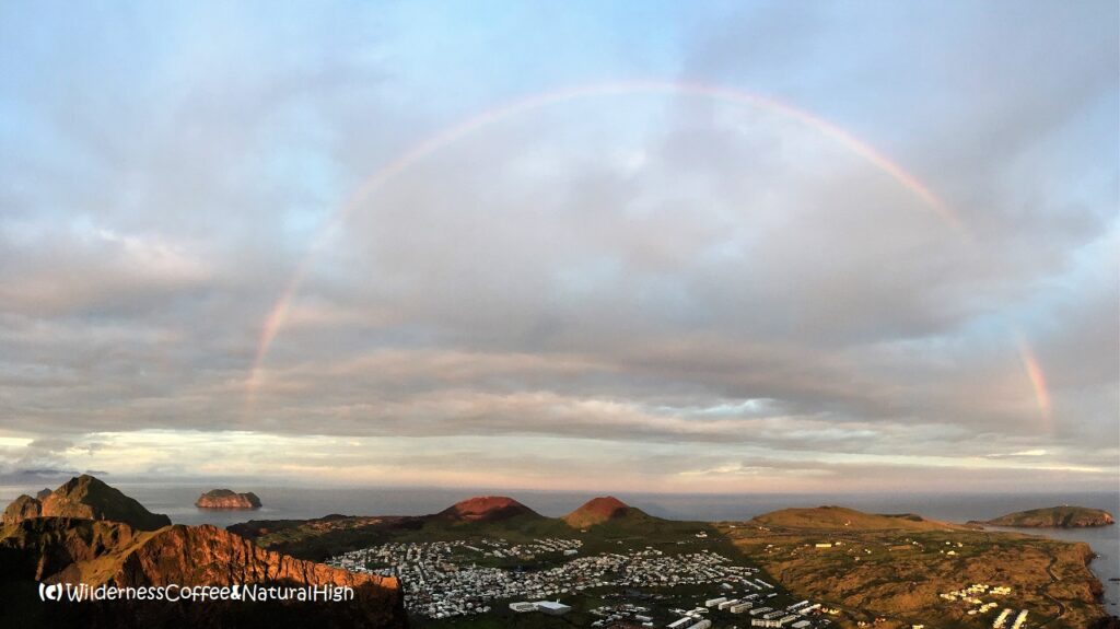 Rainbow over the twin volcanoes Rainbow over the Vestmannaeyjar twin volcanoes, Iceland.
