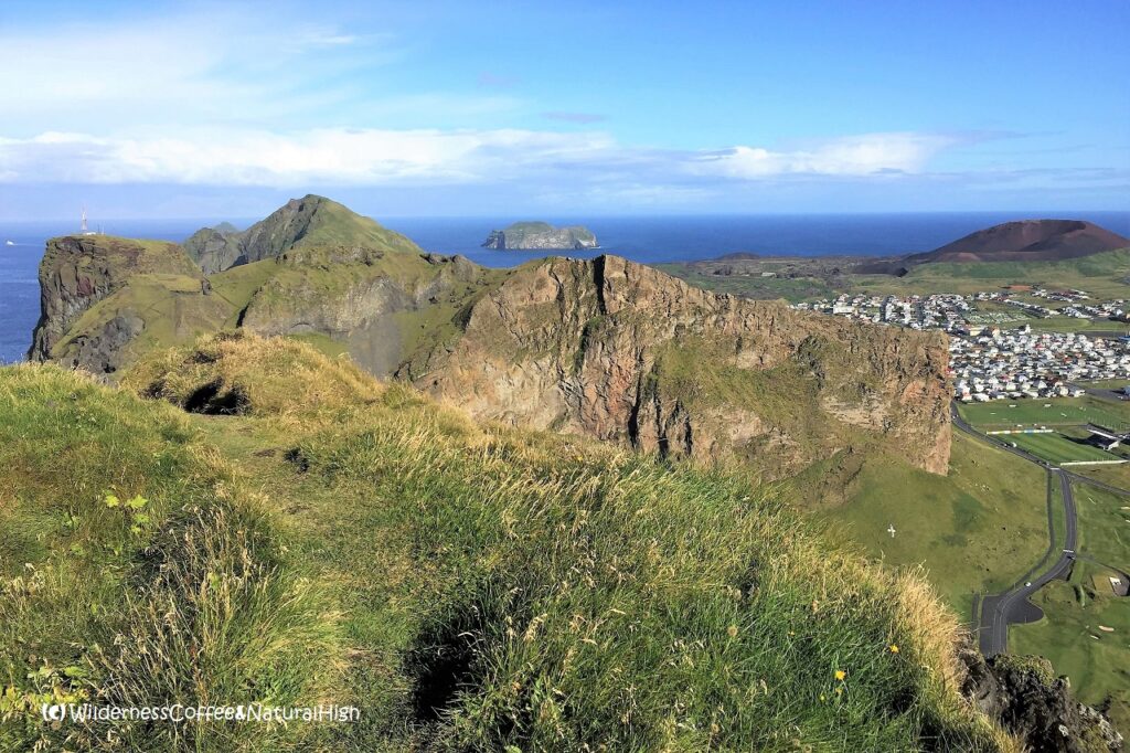 Grassy plateau on the first ridge View from Blátindur into Herjólfsdalur, Heimaey, Vestmannaeyjar, Iceland.
