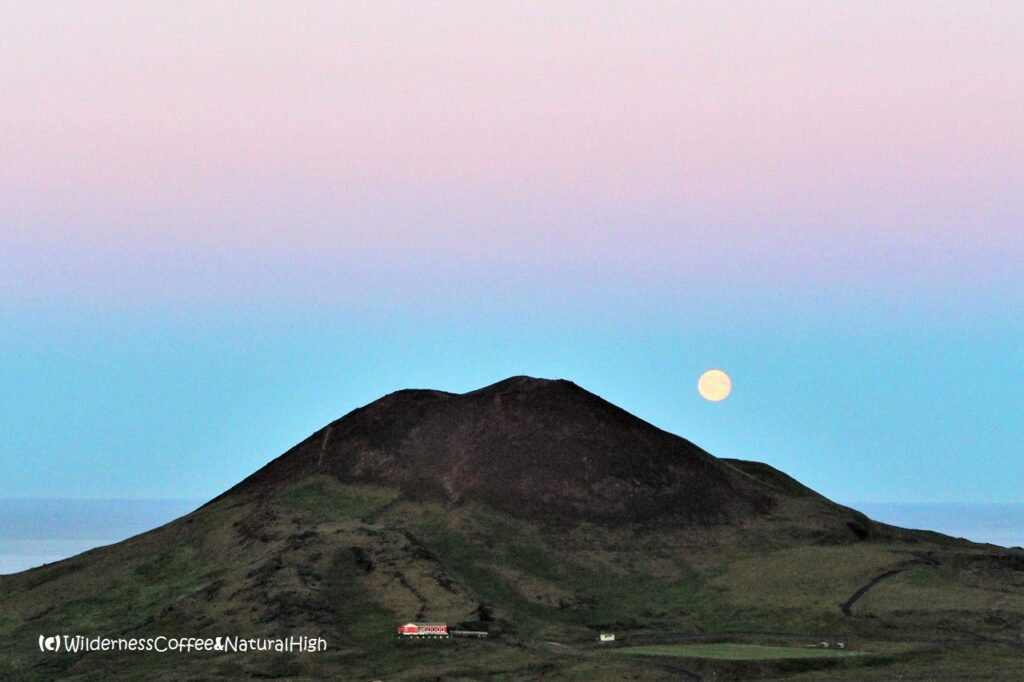 Midnight moonrise over Helgafell volcano, Vestmannaeyjar, Iceland.