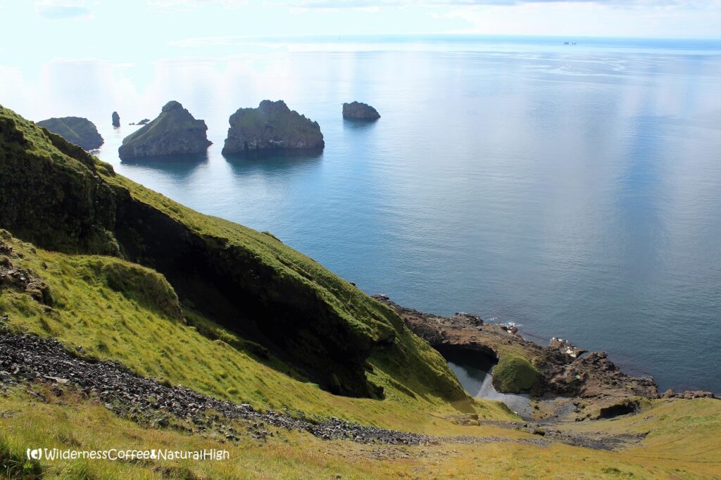 Sliding gravel slope and view to Stafsnes View to Stafsnes, Heimaey, Vestmannaeyjar, Iceland.