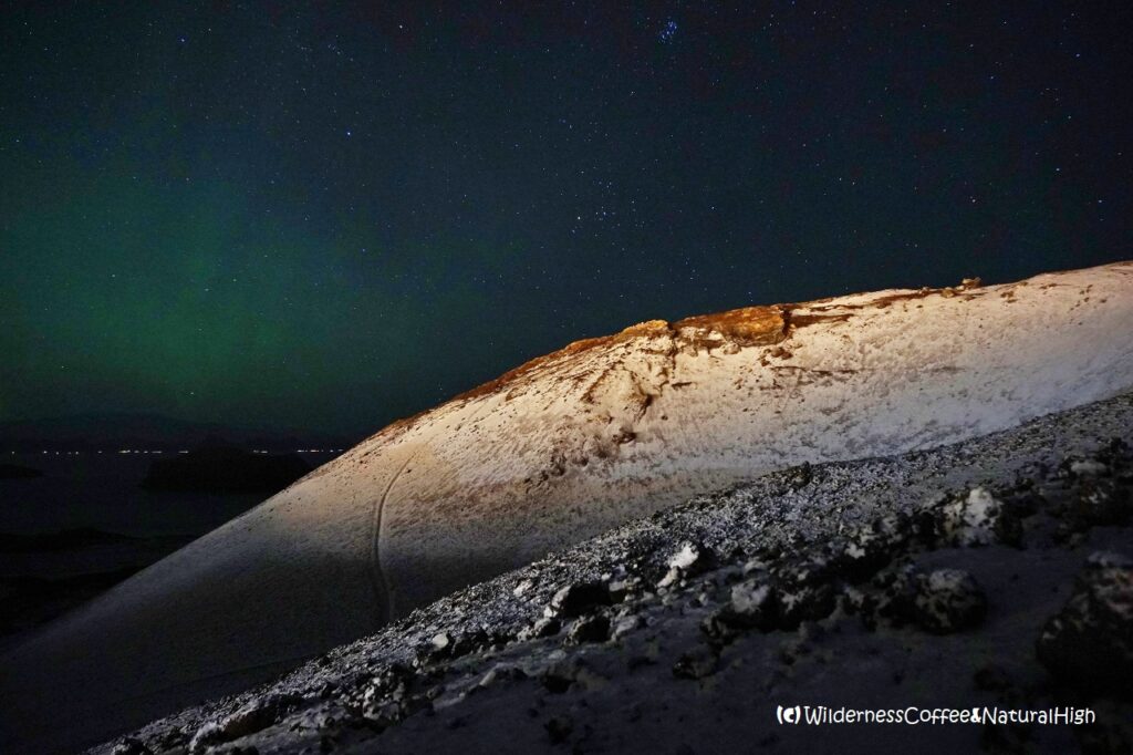 Eldfell volcano with snow and northern lights, Heimaey, Vestmannaeyjar, Iceland.