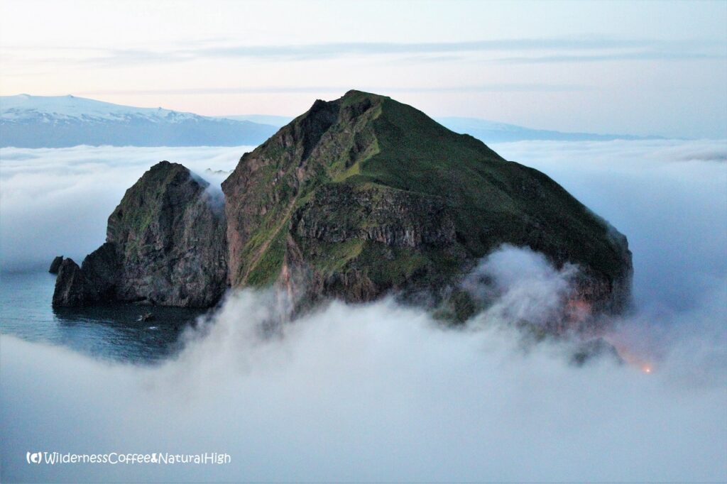 Heimaklettur engulfed by fog Heimaklettur engulfed by a dalalæða of fog, Heimaey, Vestmannaeyjar, Iceland.