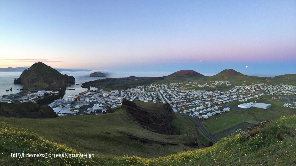 Midnight fog and moonrise Midnight fog and moonrise over Helgafell volcano, Heimaey, Vestmannaeyjar, Iceland.