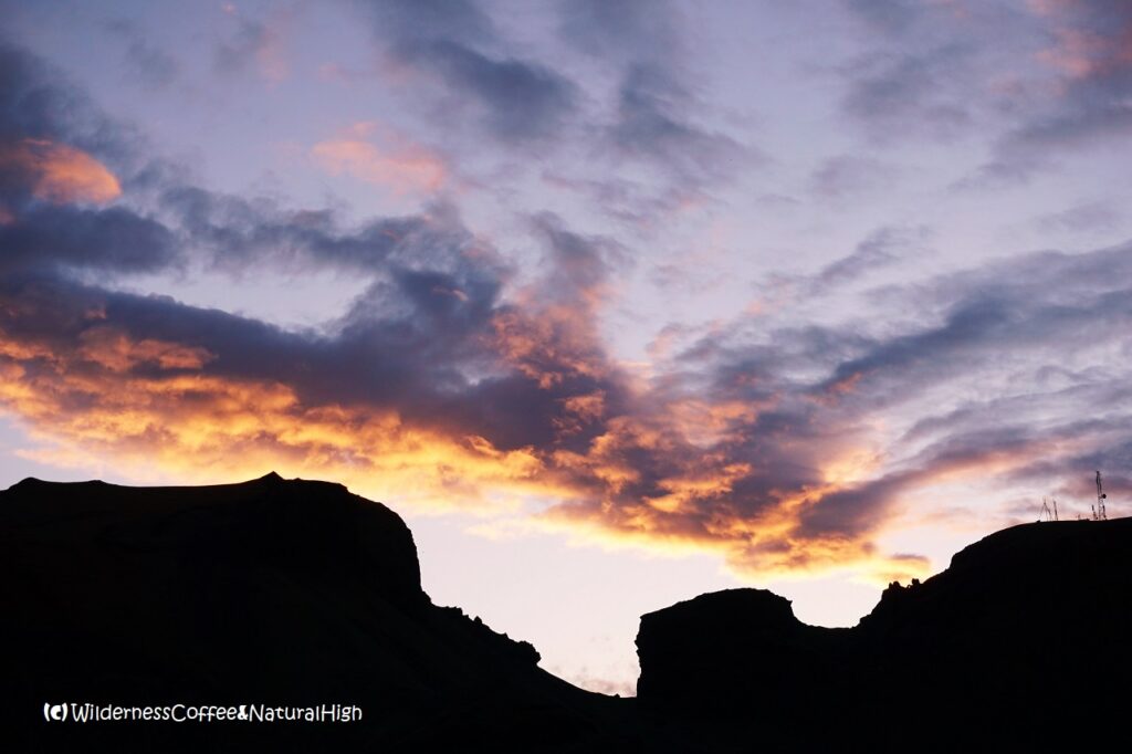 Sunset through the gap Náttmálaskarð, sunset through the gap of Klif, Vestmannaeyjar, Iceland.