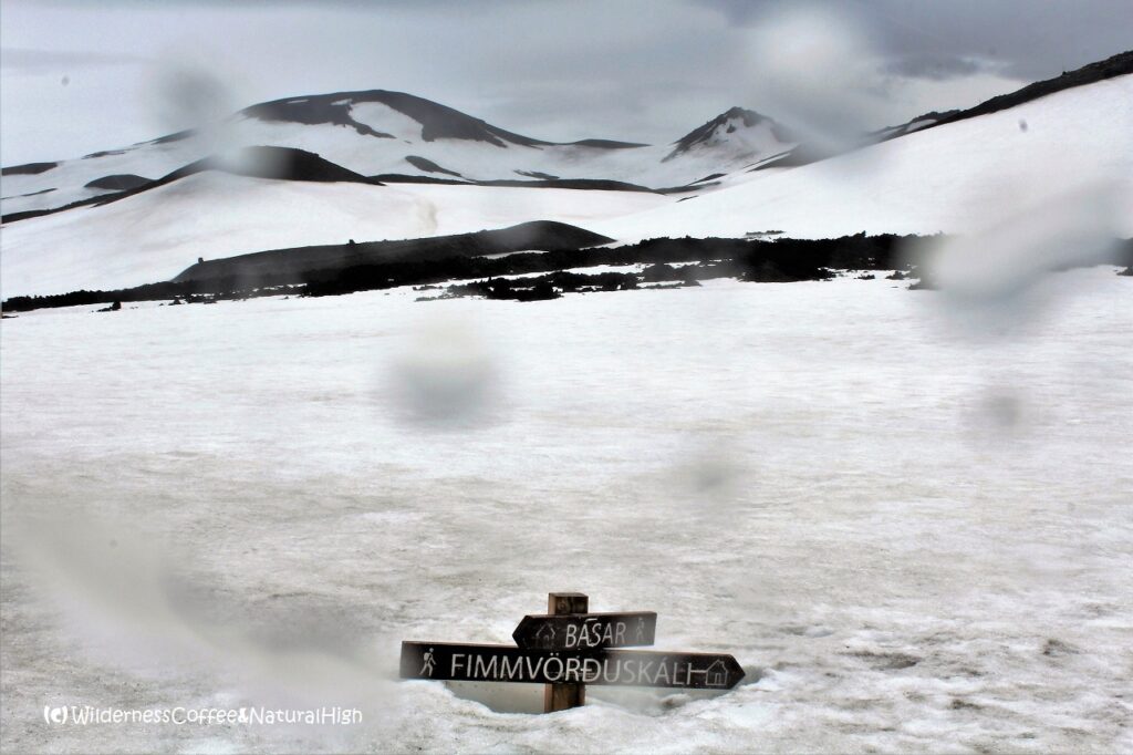 Signpost buried in snowfield Signpost in the snow, Fimmvörðuháls walking route, Iceland.